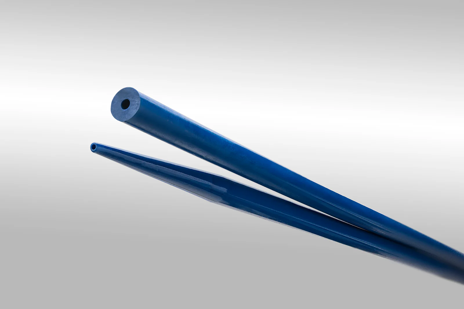 Blue catheter tubing shown at two diameters