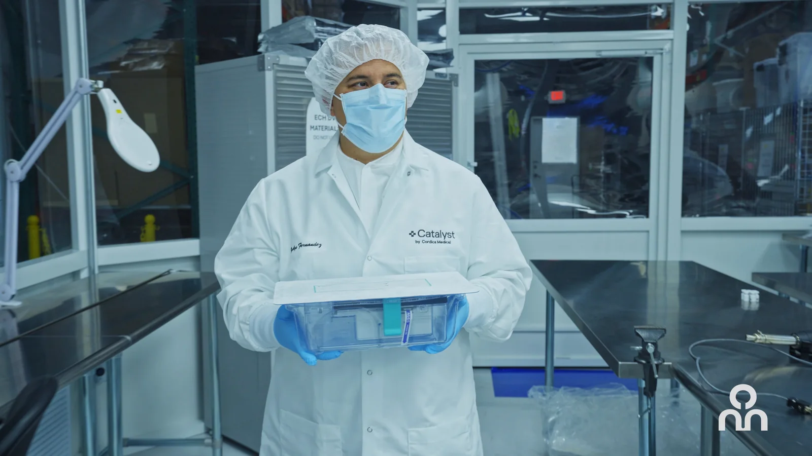 Production operator handling components within a controlled manufacturing area