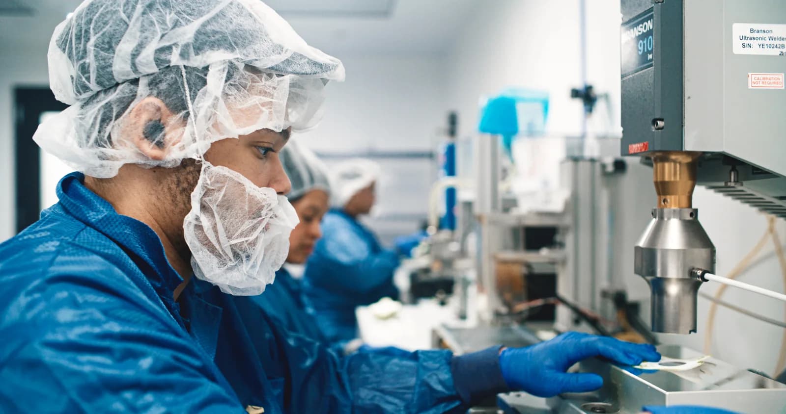 Operator working at a medical-device manufacturing station in Haverhill
