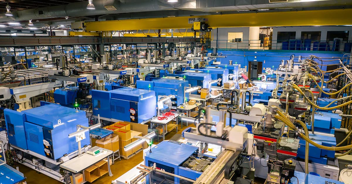 High-volume medical molding production floor with rows of equipment