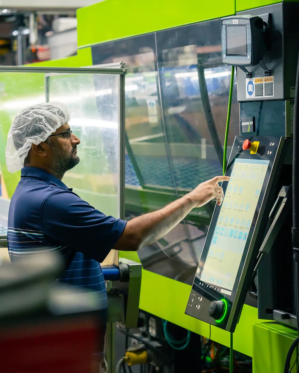 Cordica operator monitoring an injection molding machine