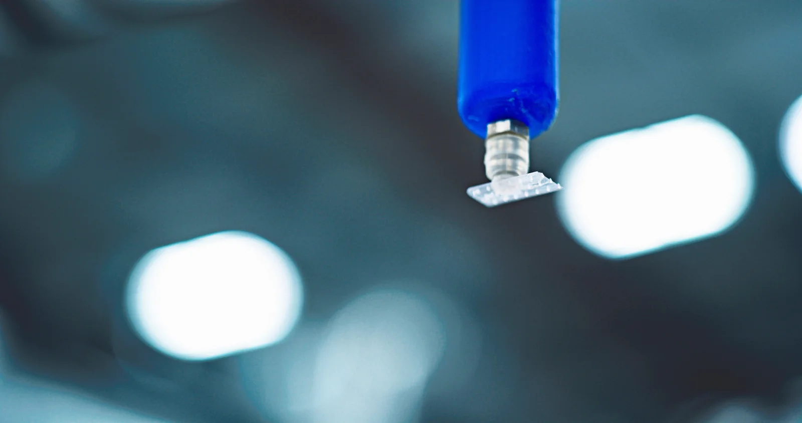 Gloved operator performing a close process check at a manufacturing workstation