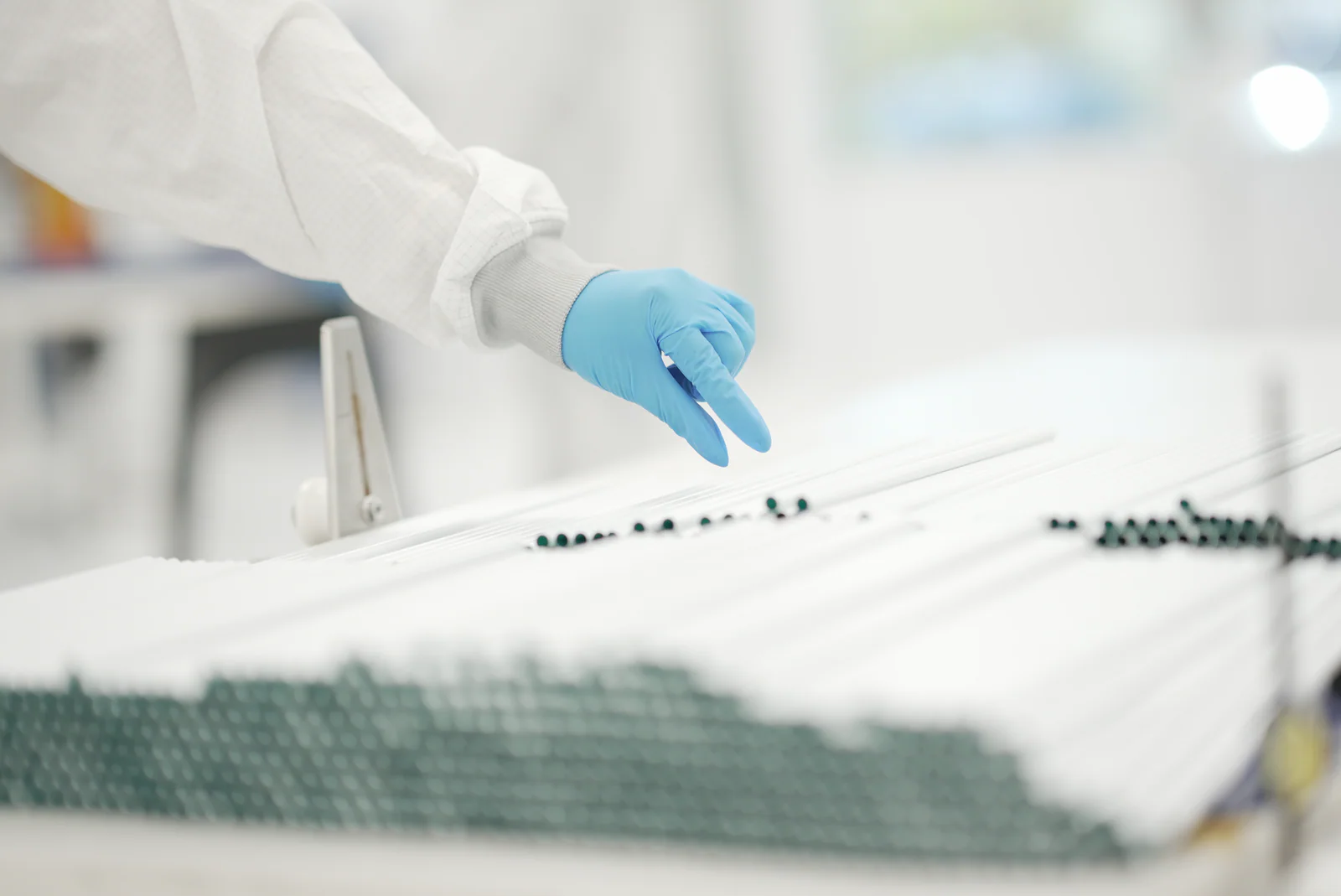 Cleanroom operator handling lengths of extruded medical tubing