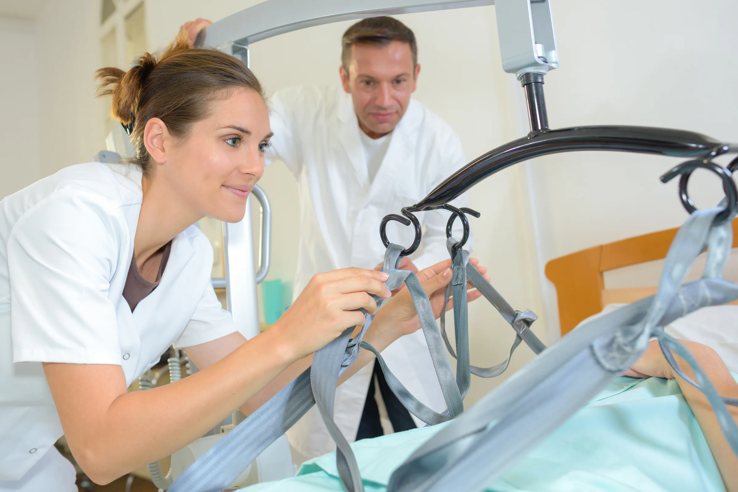 Care team using a patient lift sling during a transfer