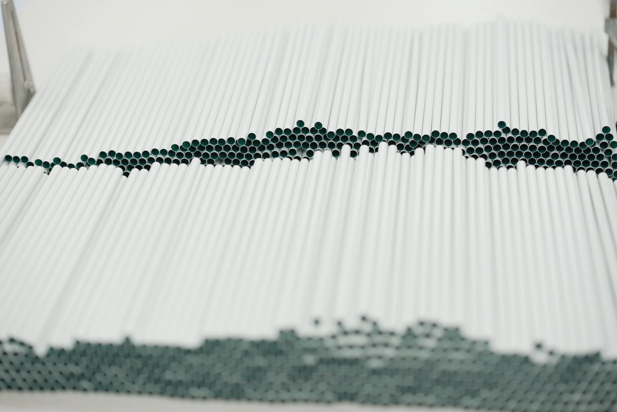 Rows of precision medical tubing with visible open tube profiles