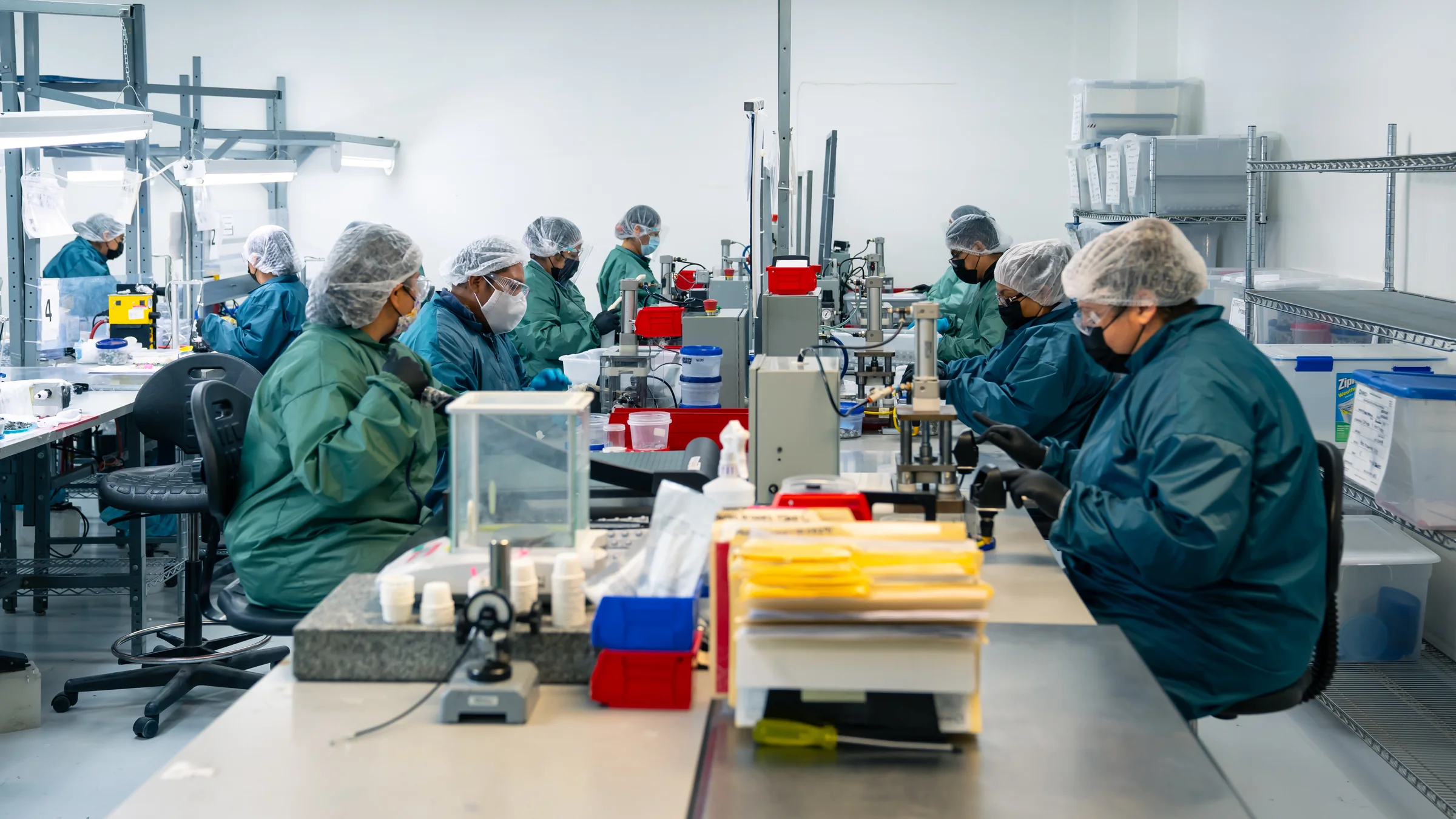 Production team working across medical-device assembly stations